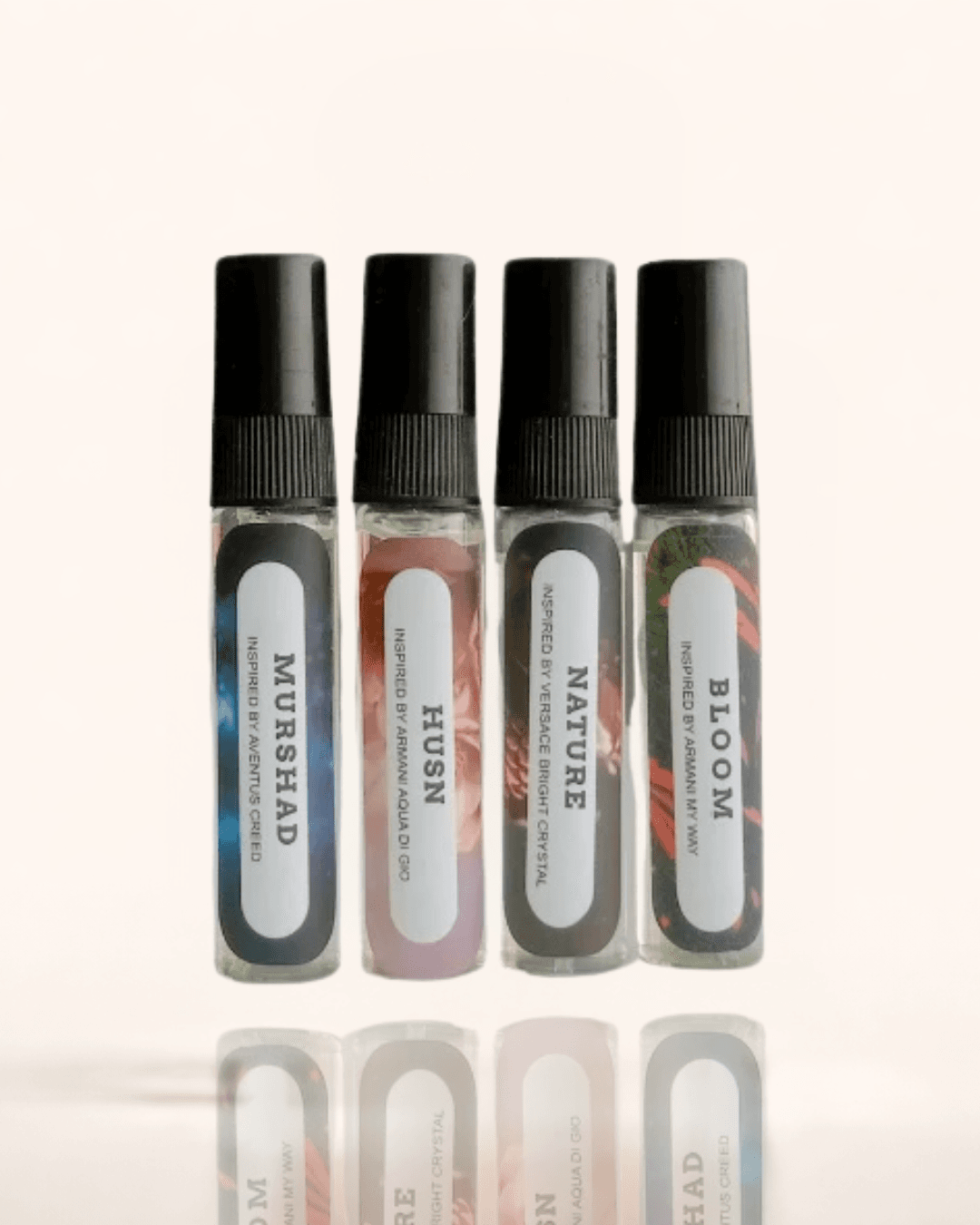 Azadi Tester Kit, Scents Enclave — four small black-capped sample sprays in a row, labelled Murshad, Husn, Nature and Bloom